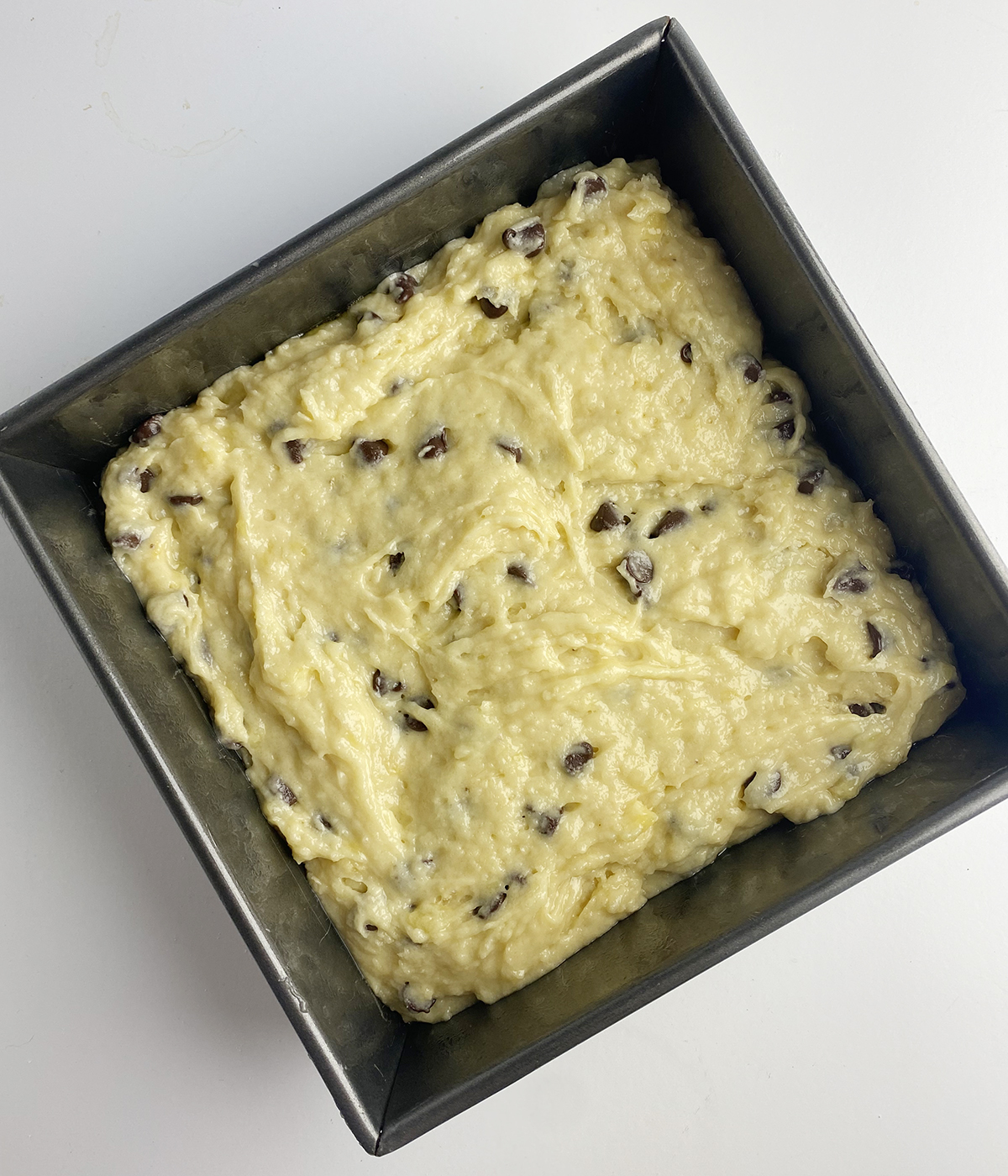 Banana chocolate chip cake batter in a pan.
