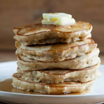 Stack of cinnamon oat pancakes on a plate.