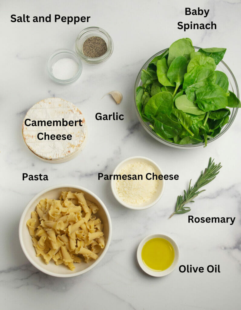 Ingredients for Pasta with Baked Camembert on a marble counter.