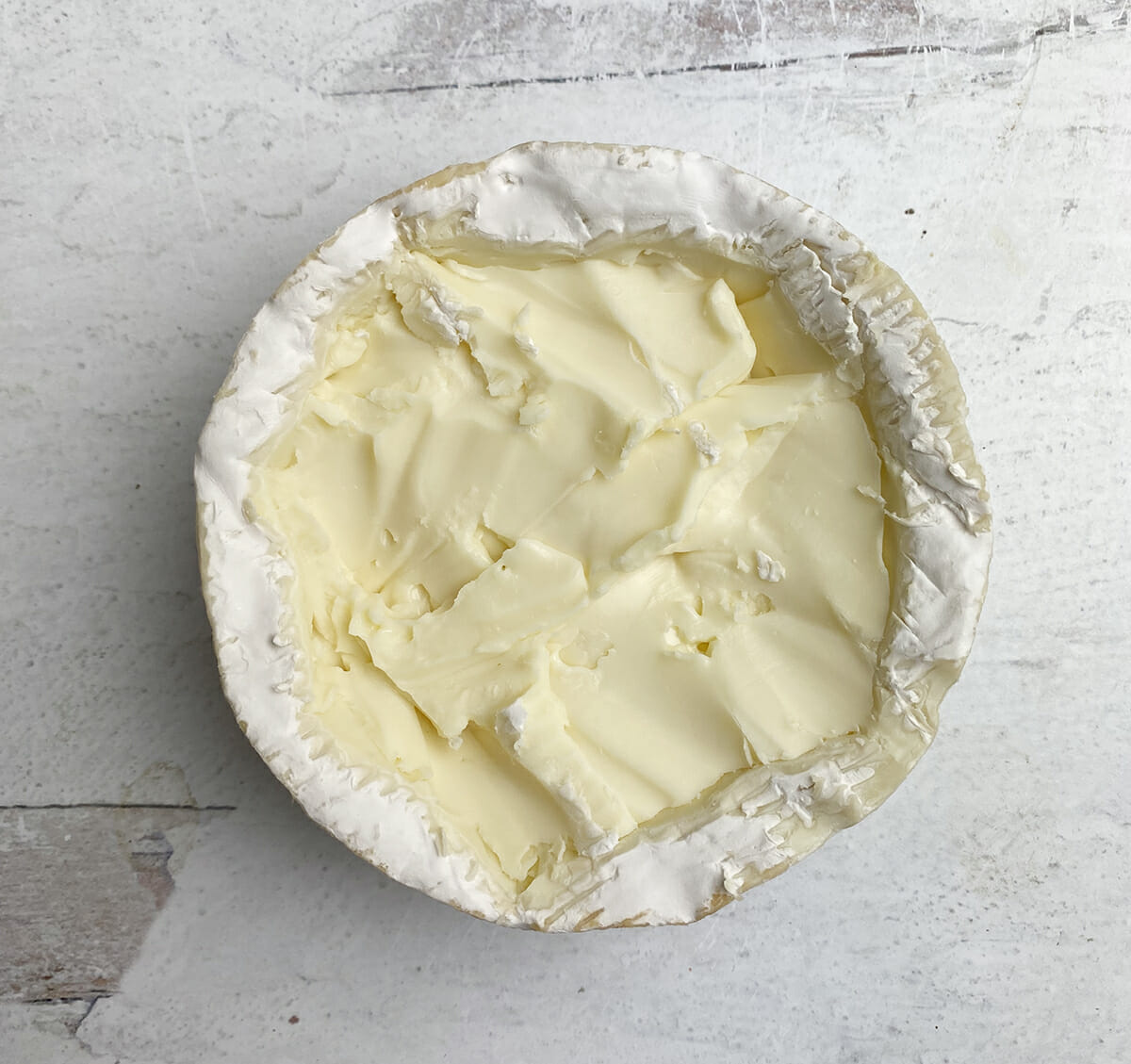Camembert wheel with top rind cut off.