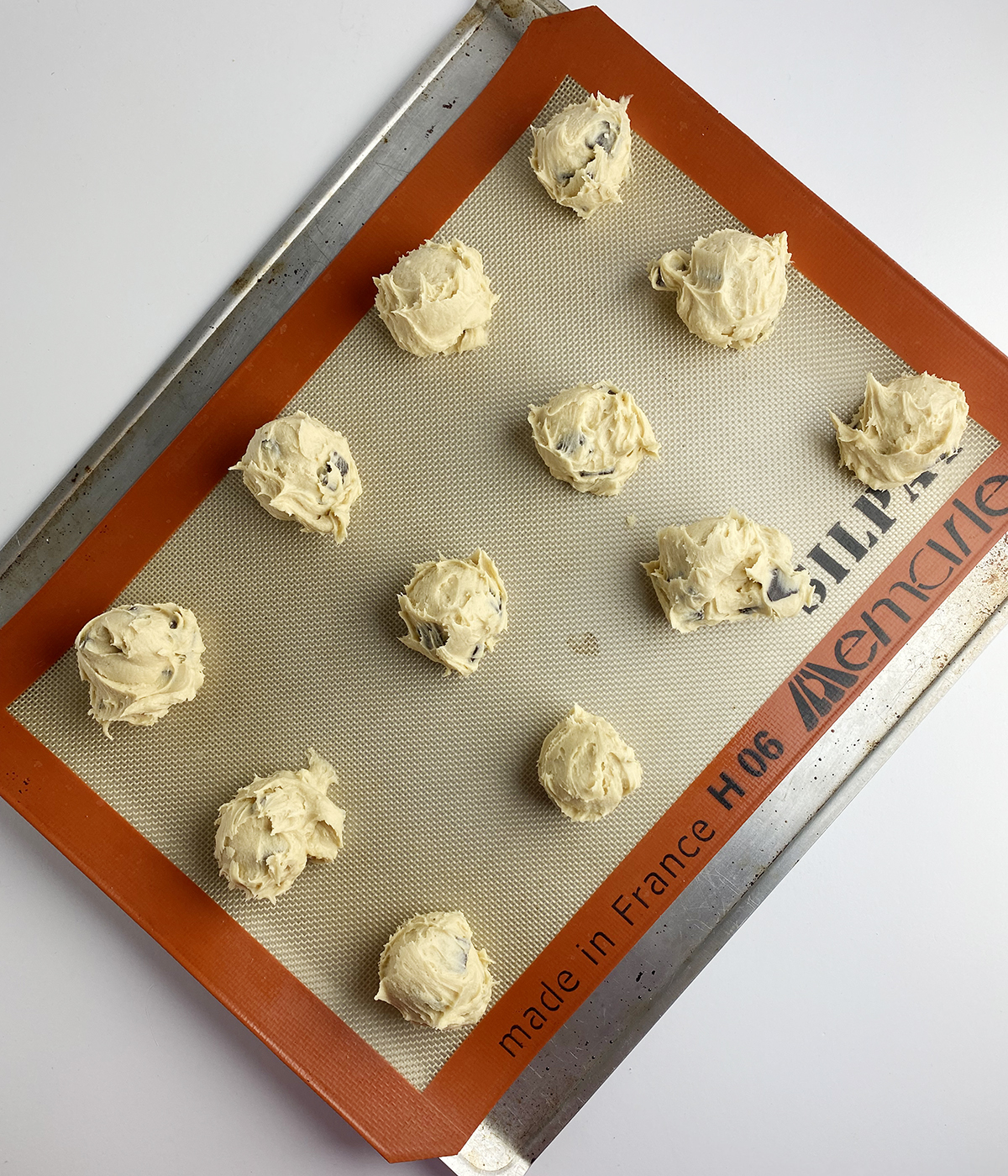 Scoops of Blue Dory cookie dough on a cookie sheet ready for the oven.