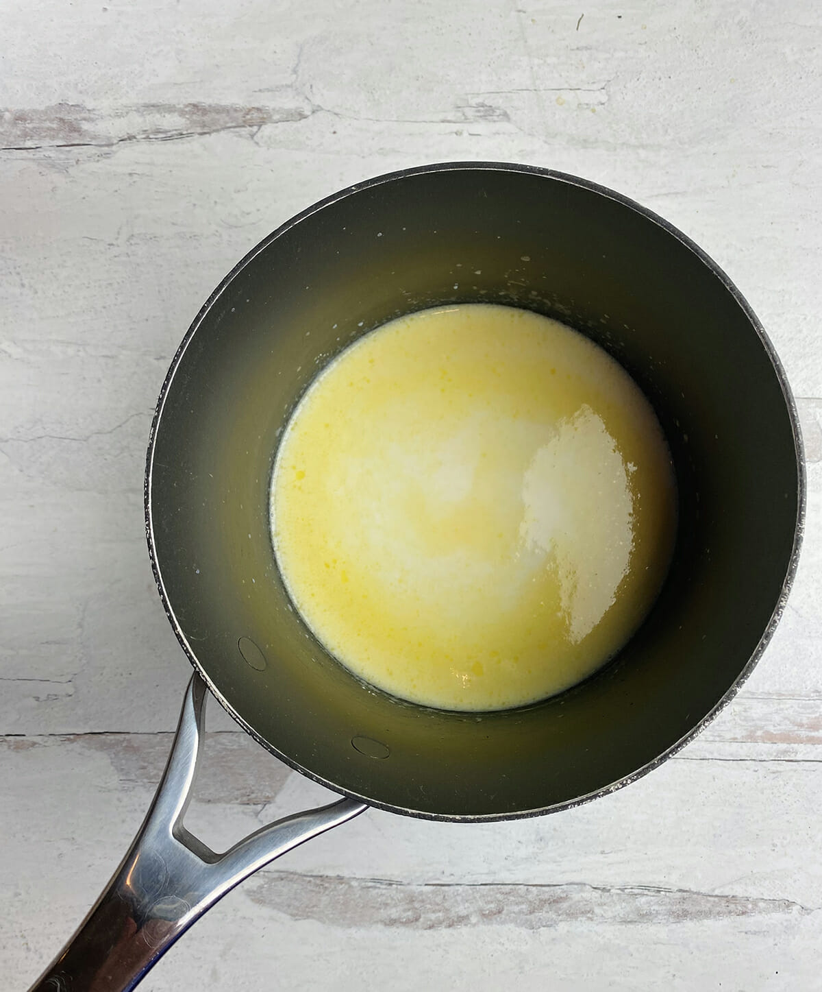 Melted butter with milk in a pot.