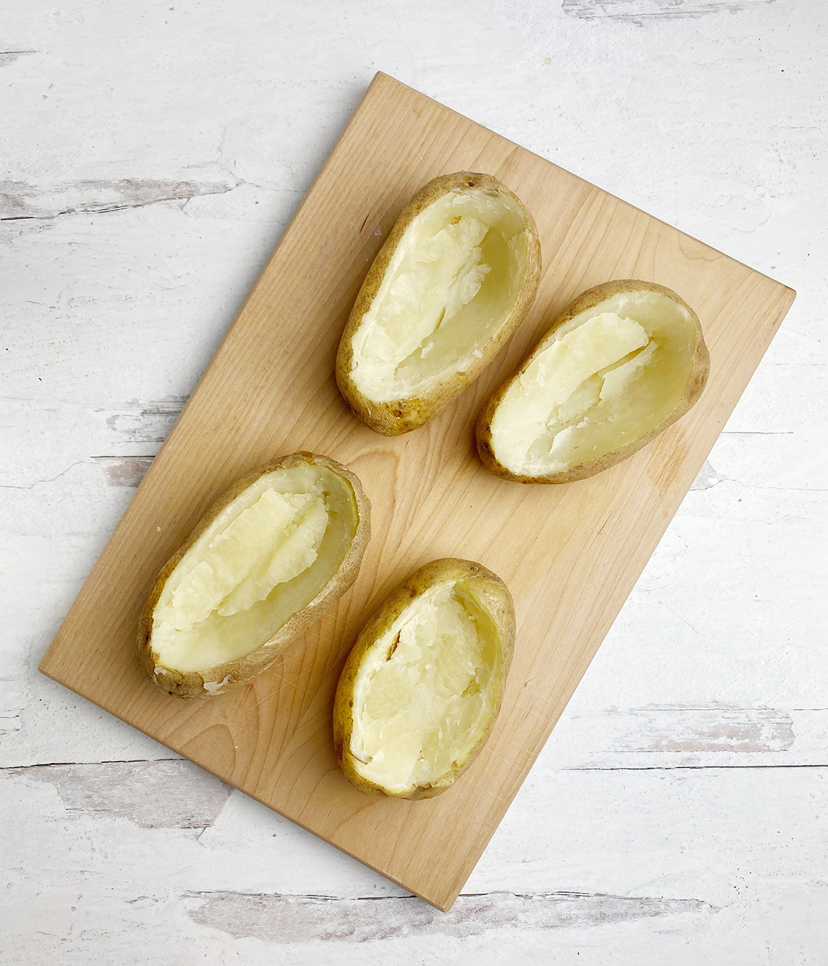 Baked potatoes with the interior potato scooped out.