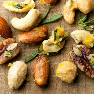 Easy buttered orange rosemary nuts on a board.