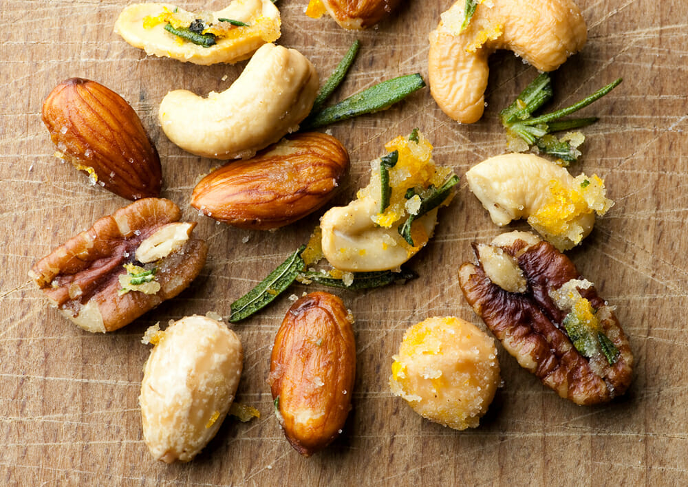 Easy buttered orange rosemary nuts on a board.