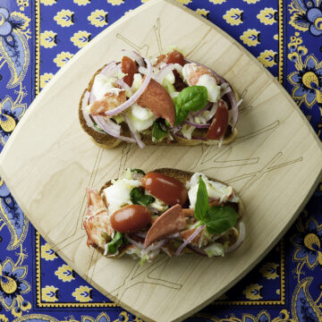 Lobster Bruschetta on a wooden board.