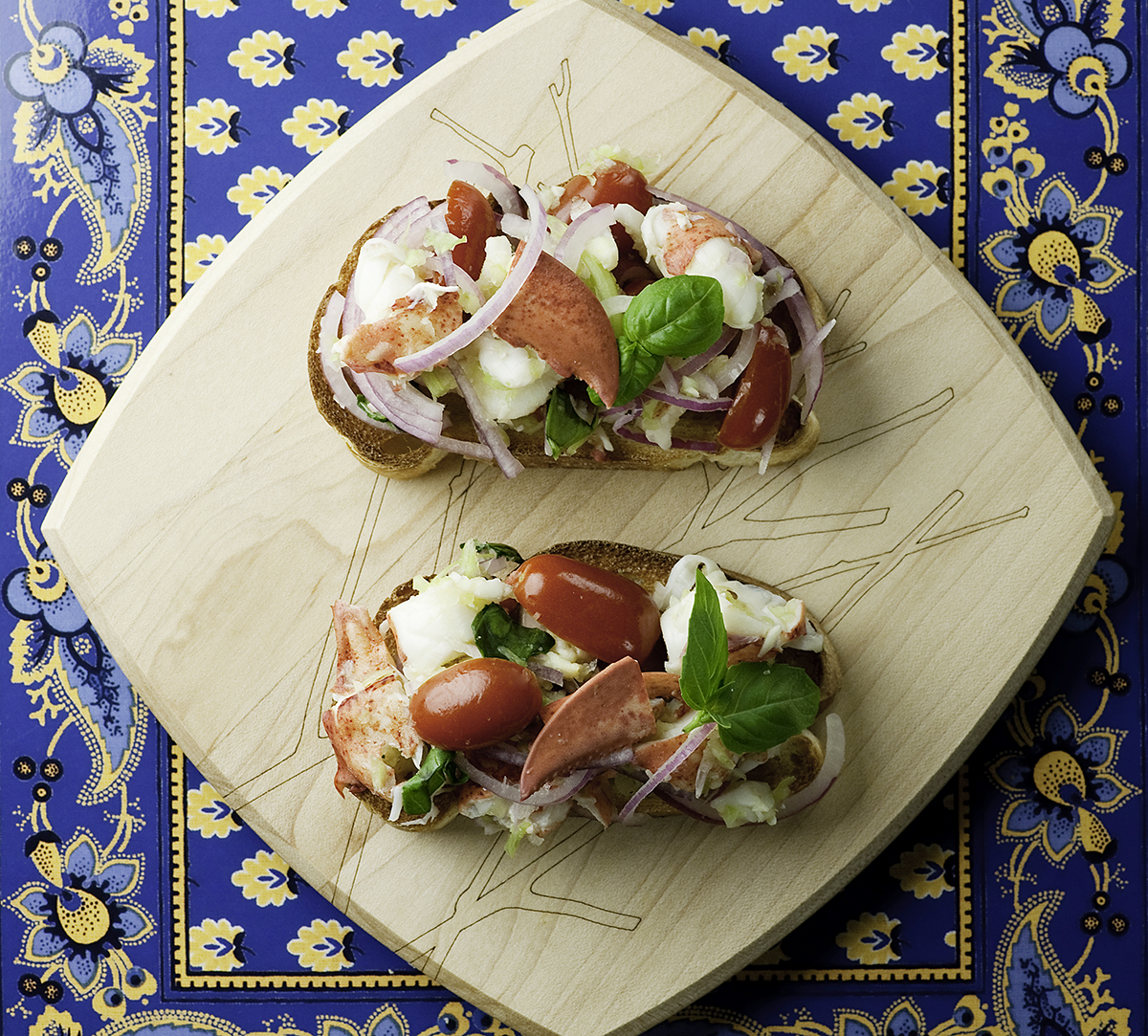 Lobster Bruschetta on a wooden board.