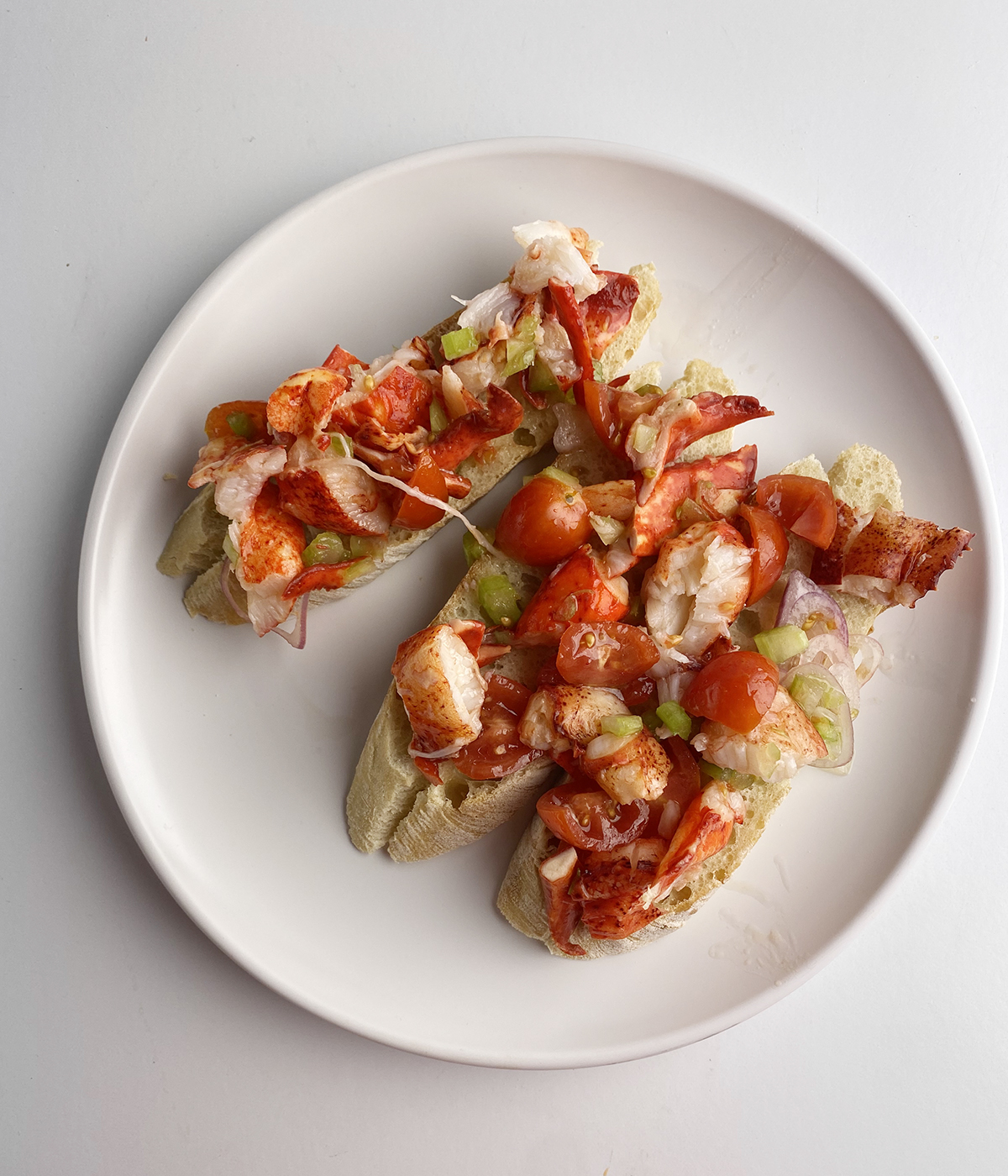 Lobster bruschetta on a plate.