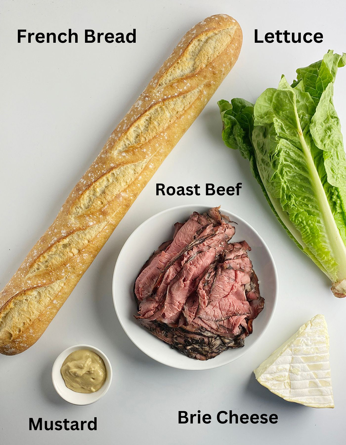 Ingredients needed for a roast beef and brie sandwich.