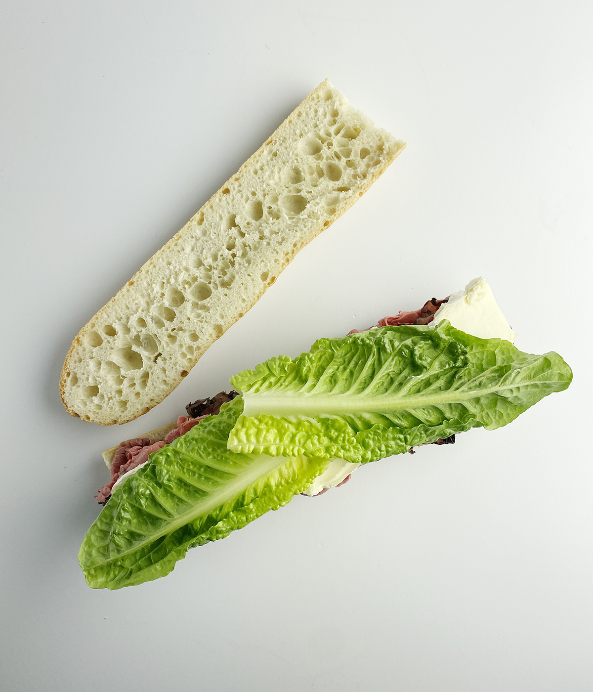 Roast Beef and Brie sandwich with lettuce.