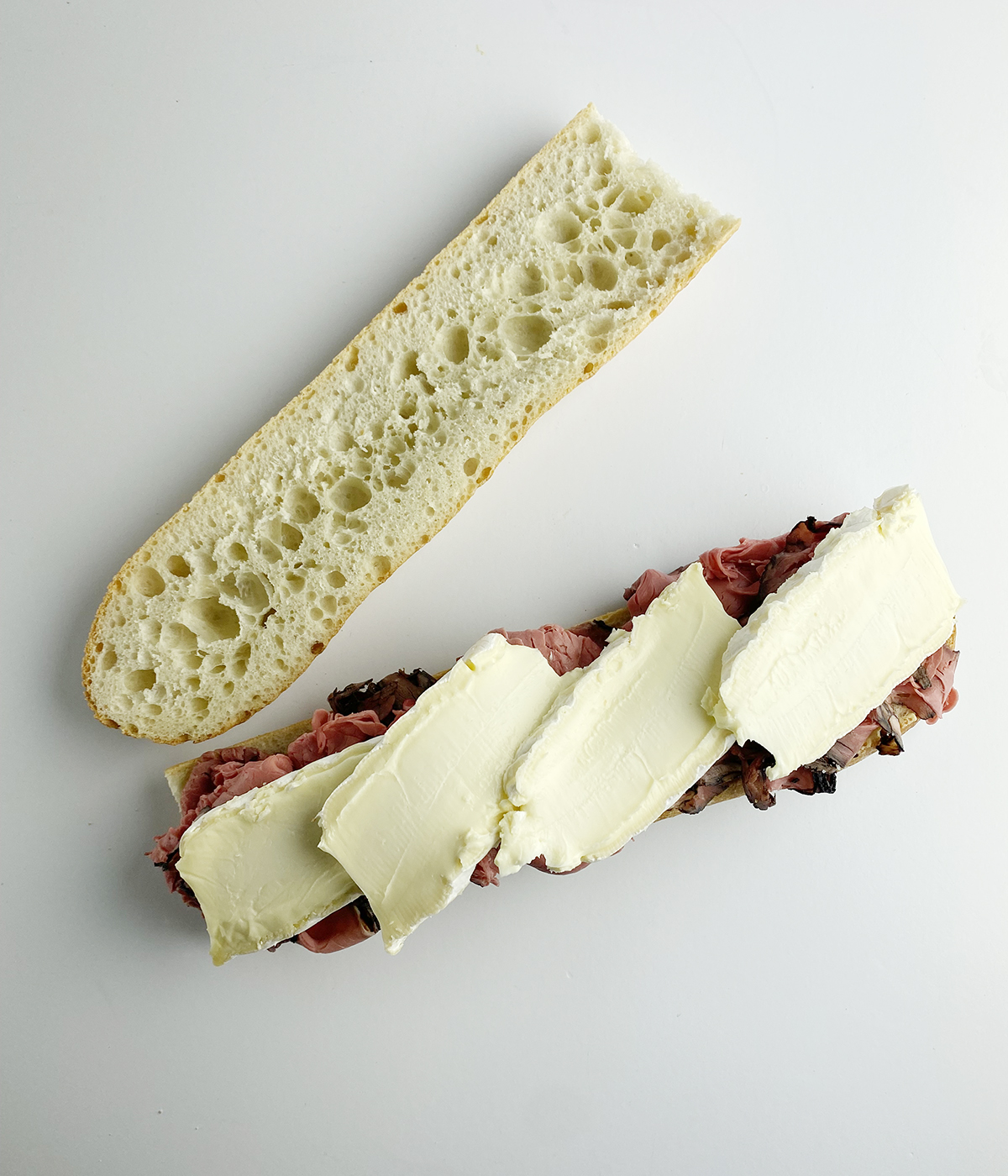 Roast beef and brie sandwiches with cheese.