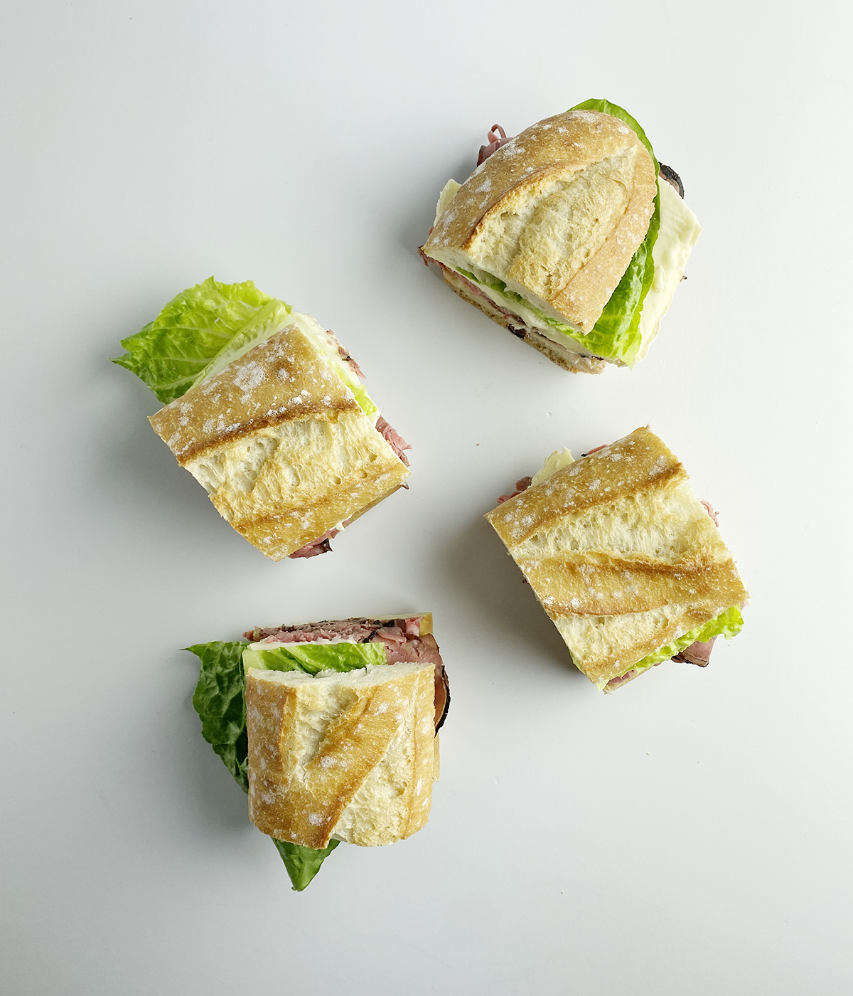 Roast Beef Brie Sandwiches cut into pieces.
