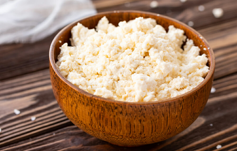 Ricotta cheese in a wooden bowl.