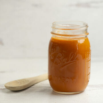 Best tomato sauce in a jar with a wooden spoon.