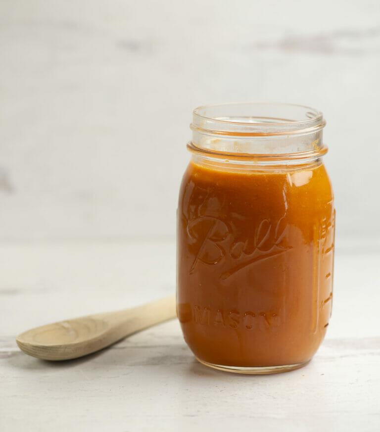 Best tomato sauce in a jar with a wooden spoon.