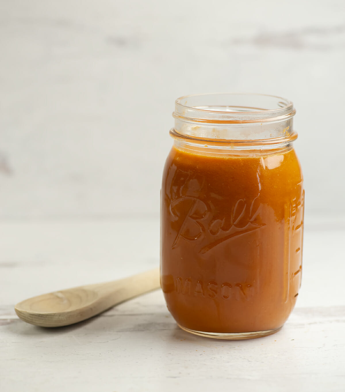 Best tomato sauce in a jar with a wooden spoon.