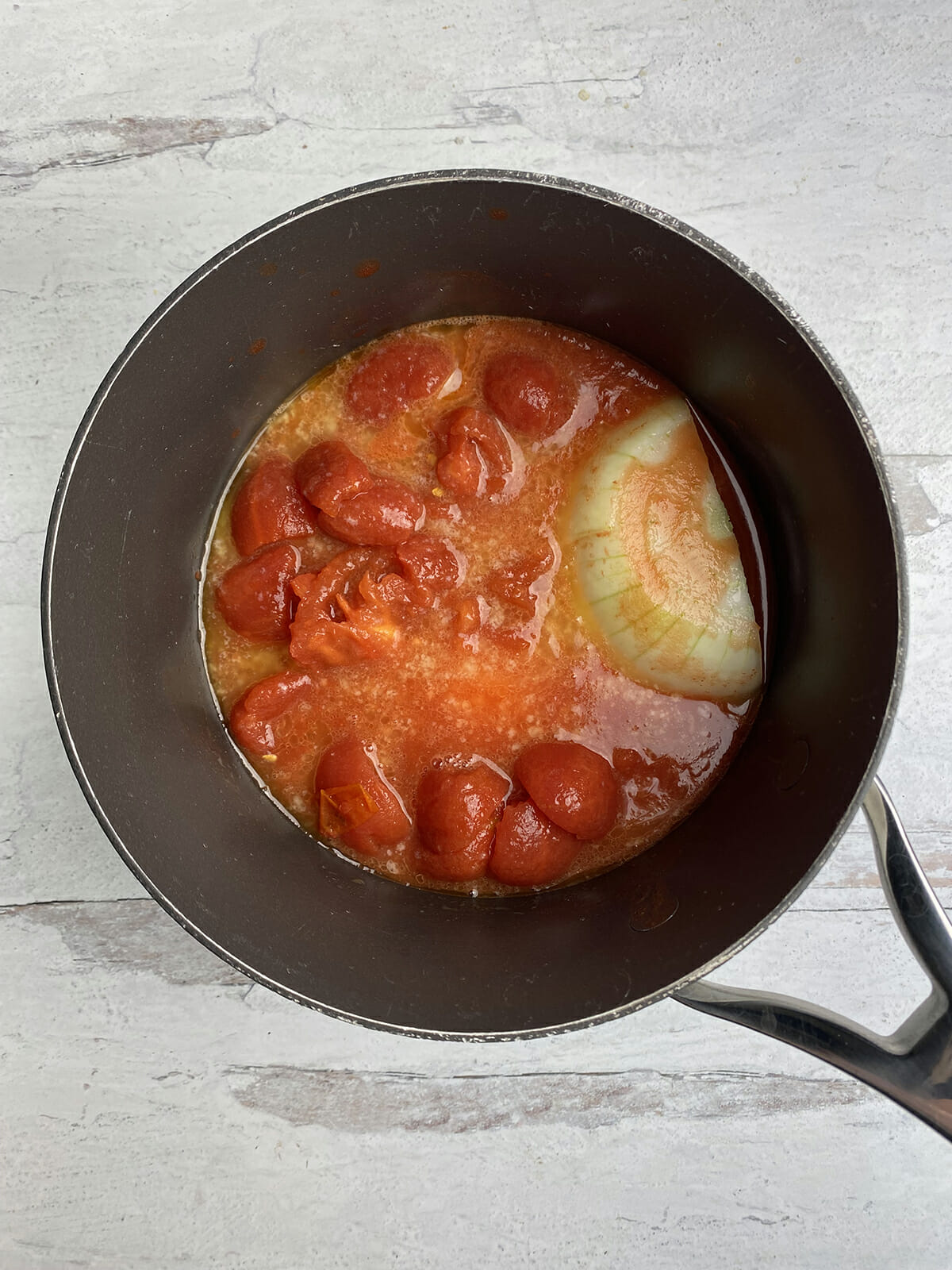 Tomato sauce simmering in a pot.