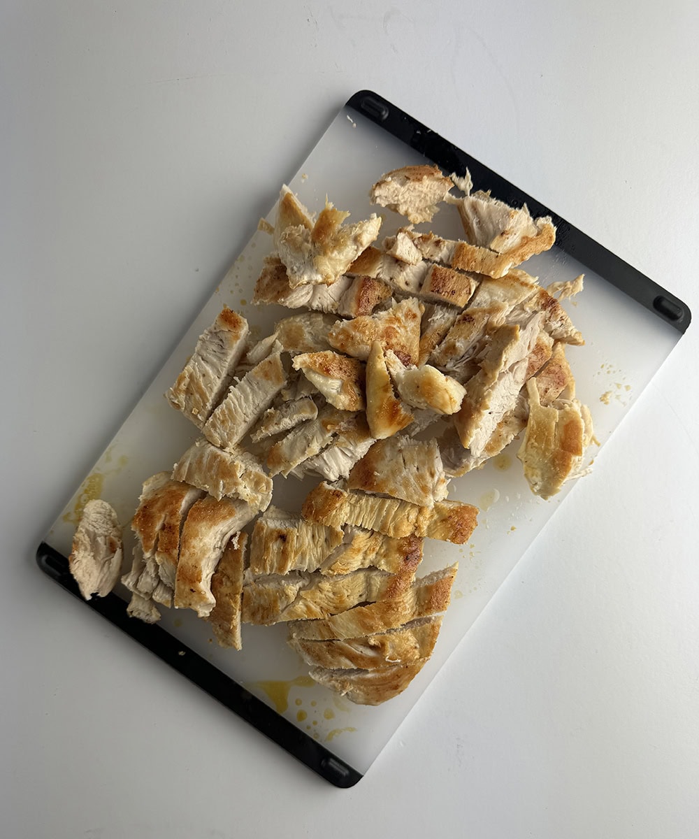 Chopped chicken on a cutting board.