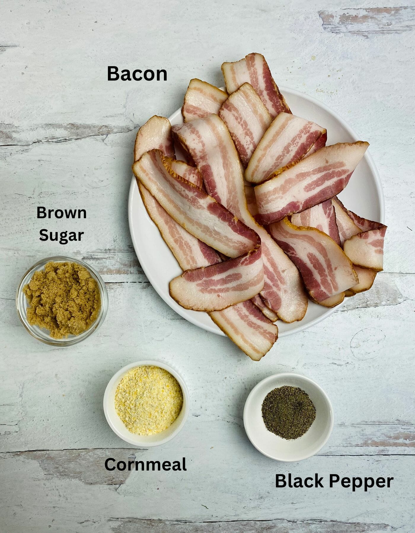 Cornmeal brown sugar bacon ingredients on a wooden board.