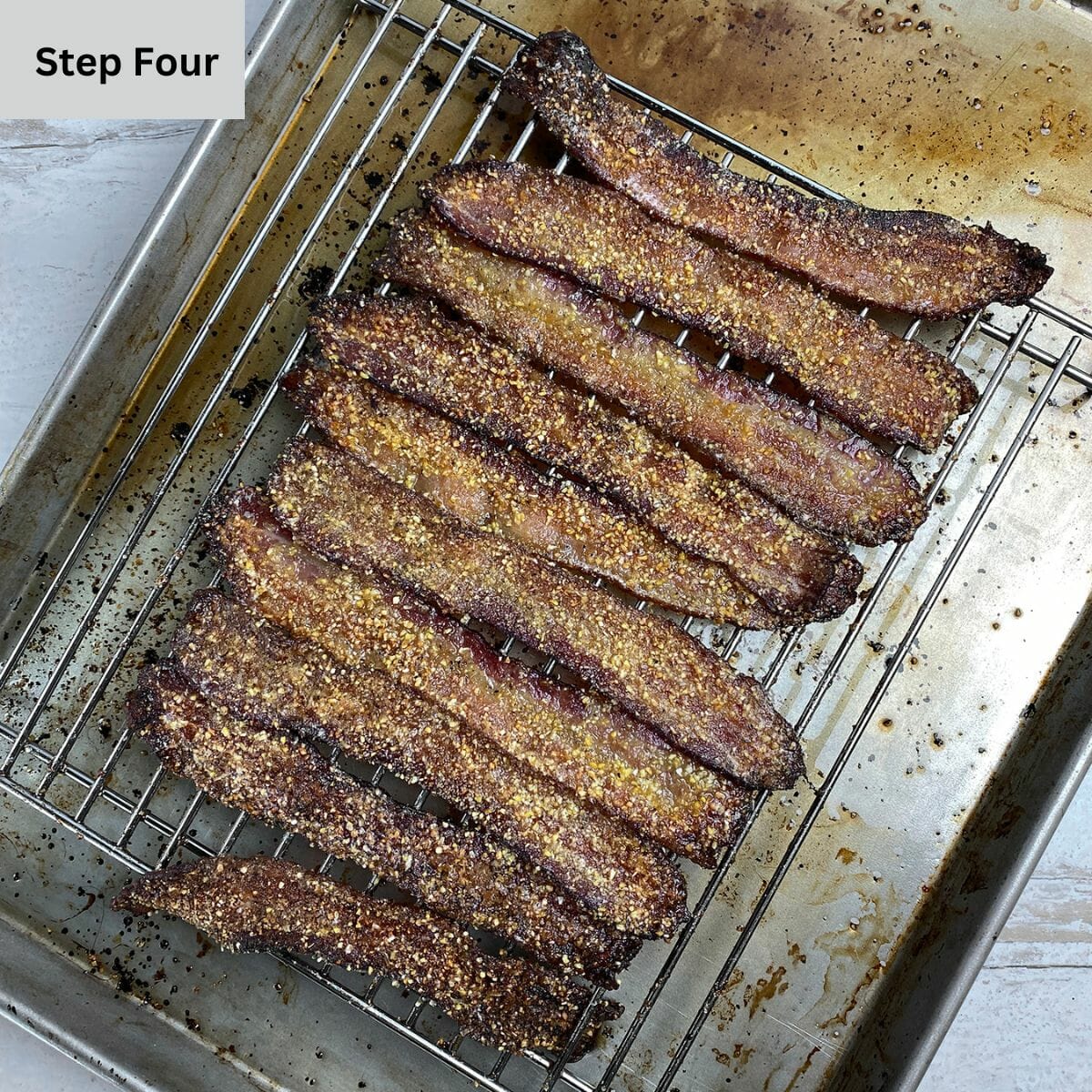 Cooked brown sugar bacon on a rack and baking pan.