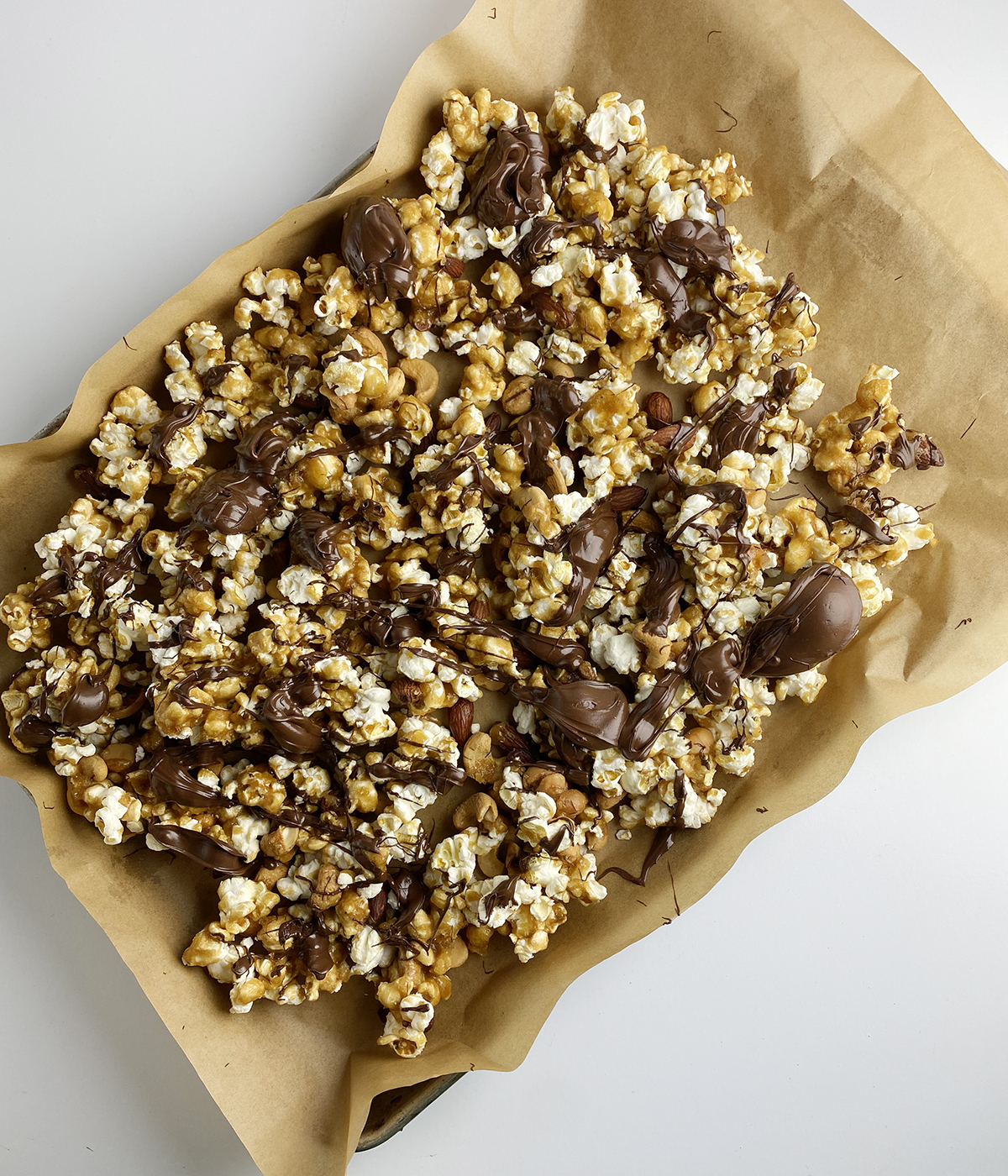 Finished reindeer crunch mix on a baking sheet lined with parchment paper.