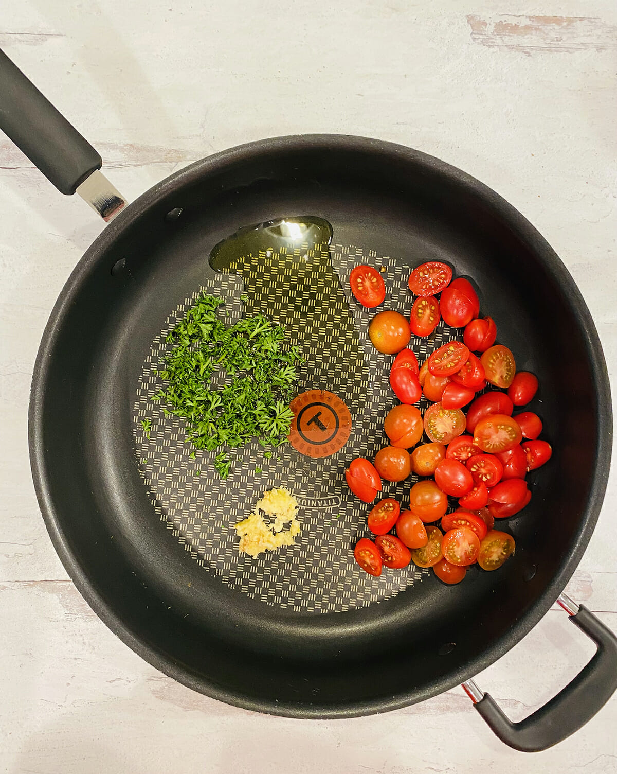 Tomato sauce with garlic and parsley in a skillet.