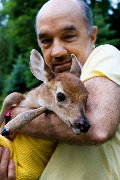 man with baby deer