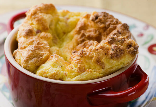 Ham and cheese soufflé in a casserole dish.