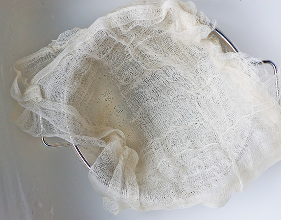 cheesecloth in colander