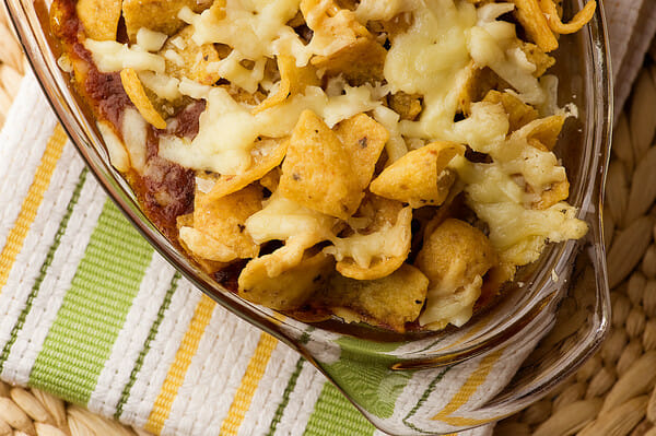 Baked Frito Chili Pie resting on a dishcloth.