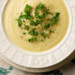 Cheesy cauliflower soup in a bowl.