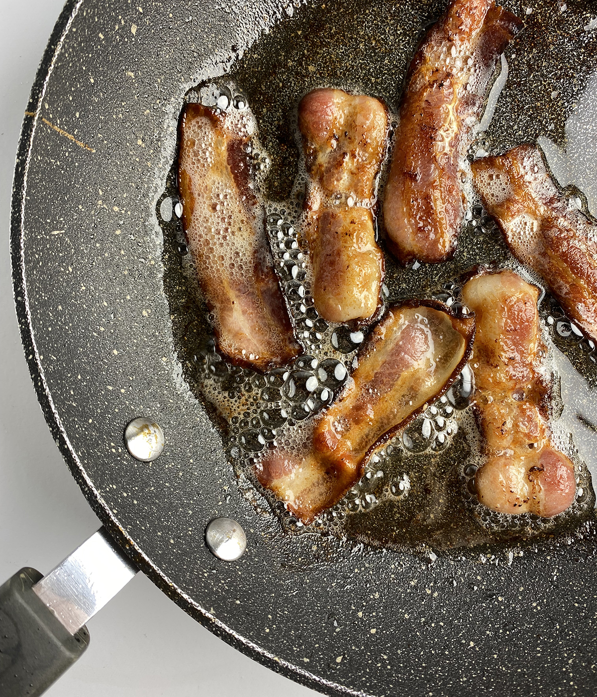 Cooked bacon in a skillet.