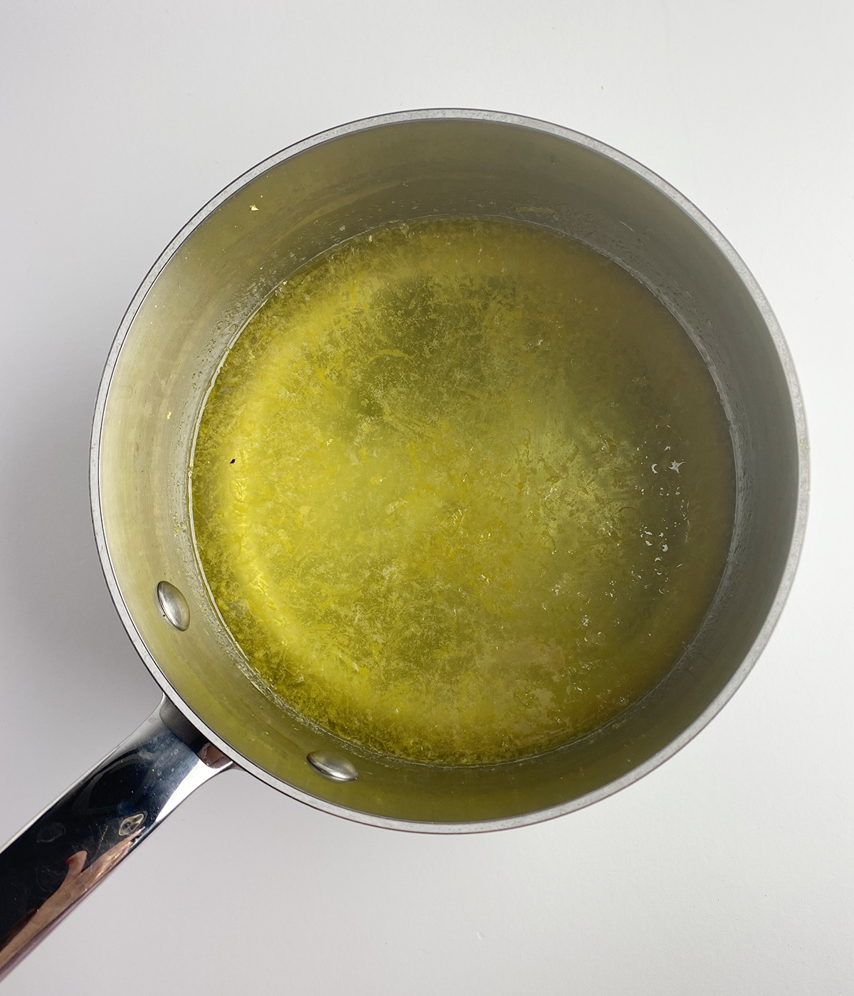 Lemon sugar syrup in a pot.