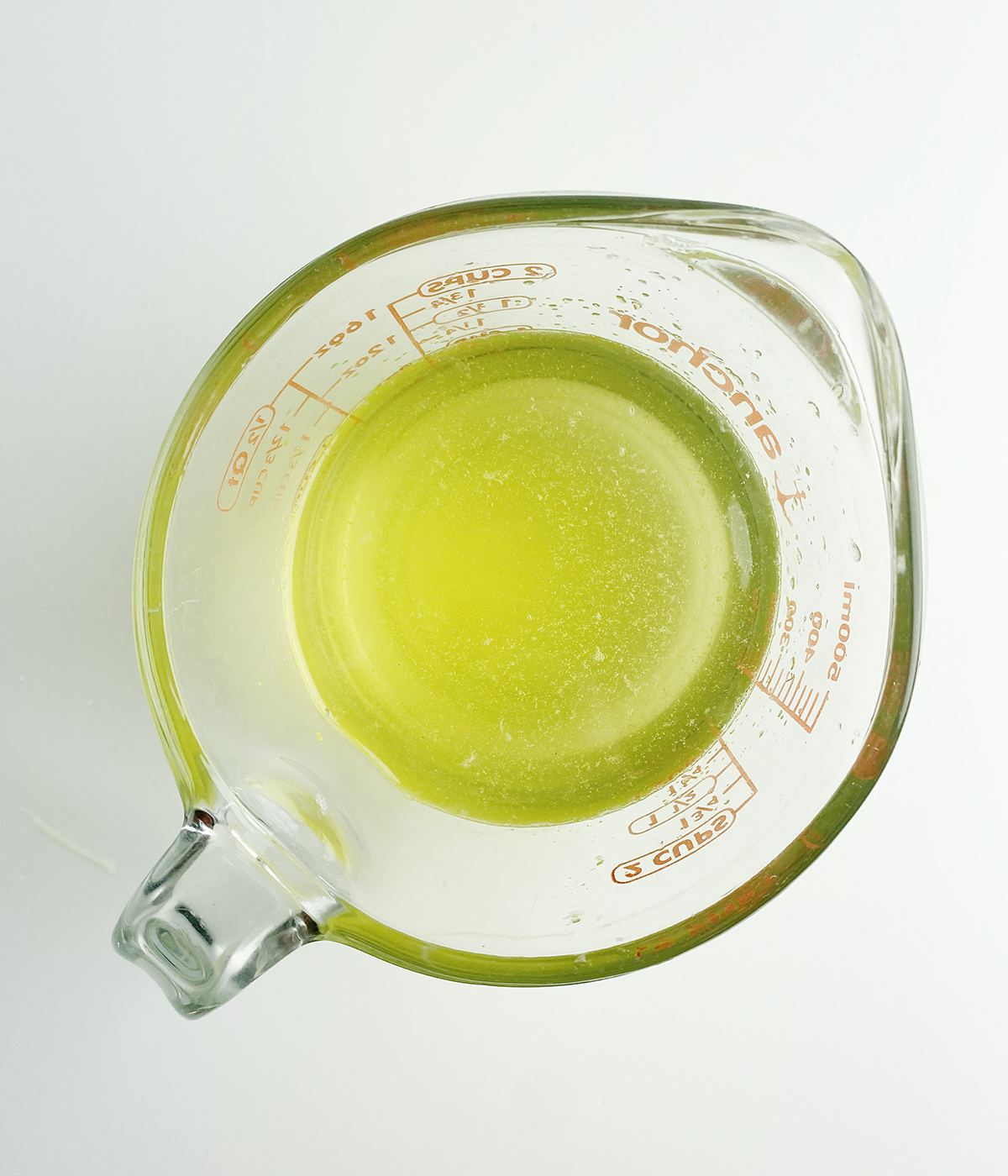 Measuring cup with lemon juice.