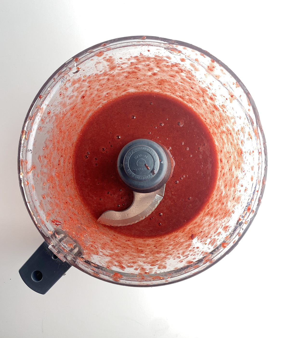 Pureed strawberries in a food processor.
