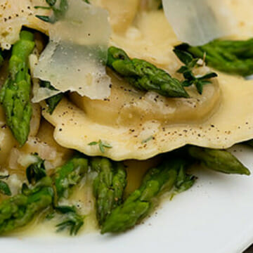 Ravioli with white wine butter sauce on a plate.