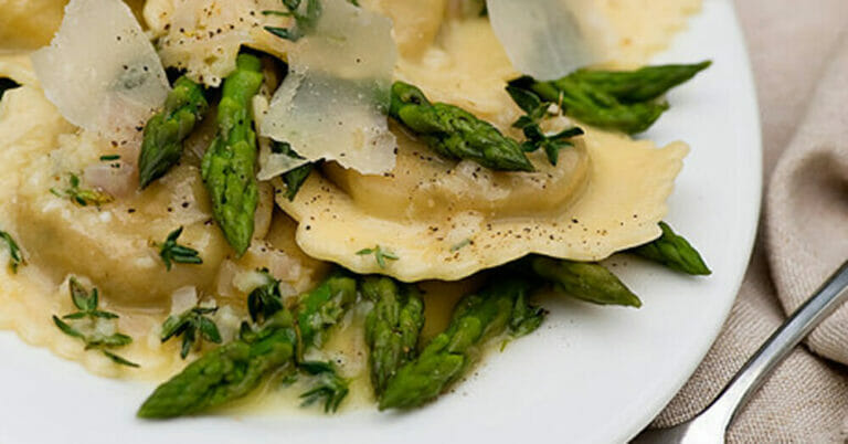 Ravioli with white wine butter sauce on a plate.