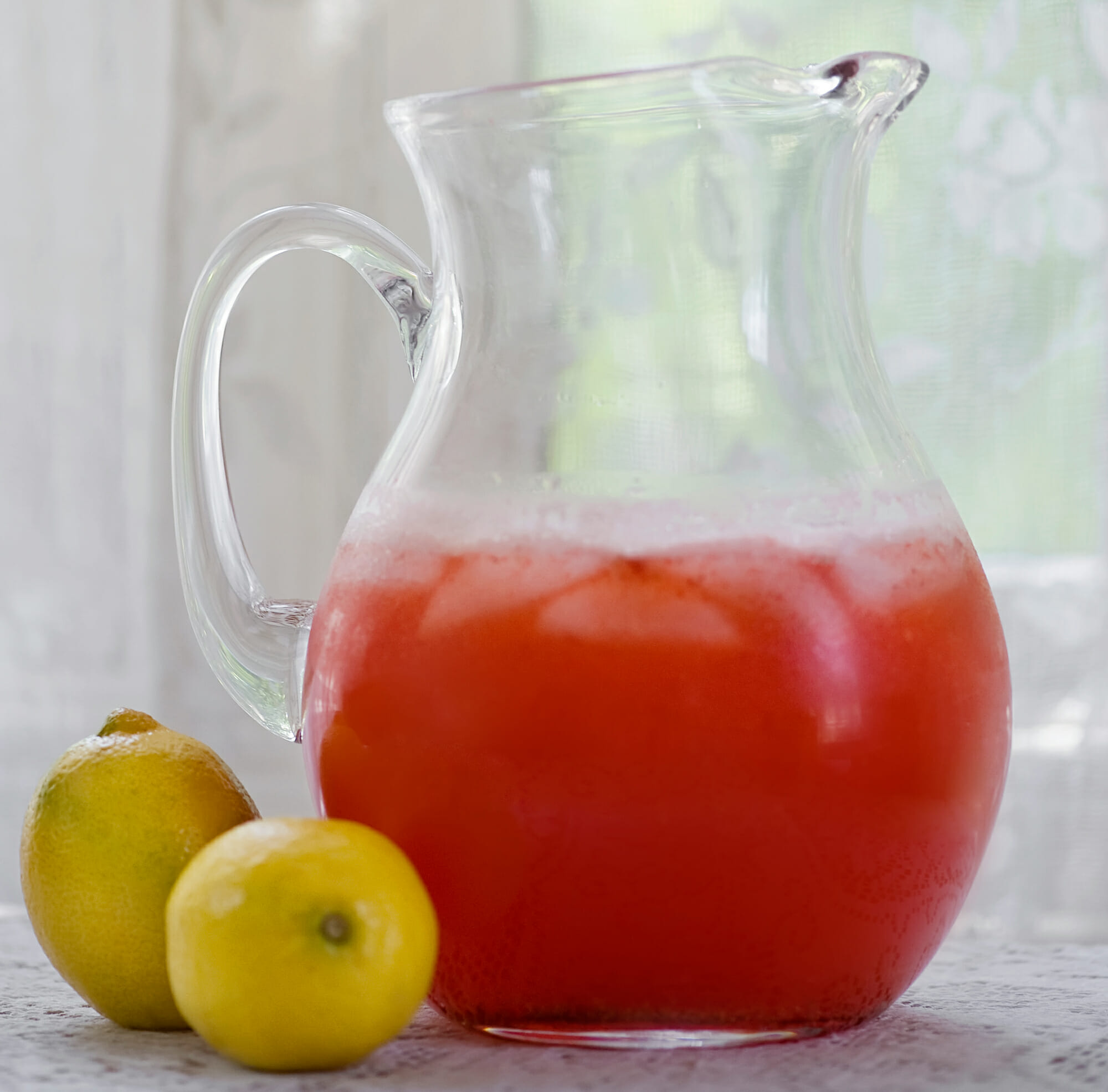 Strawberry lemonade in a pitcher.