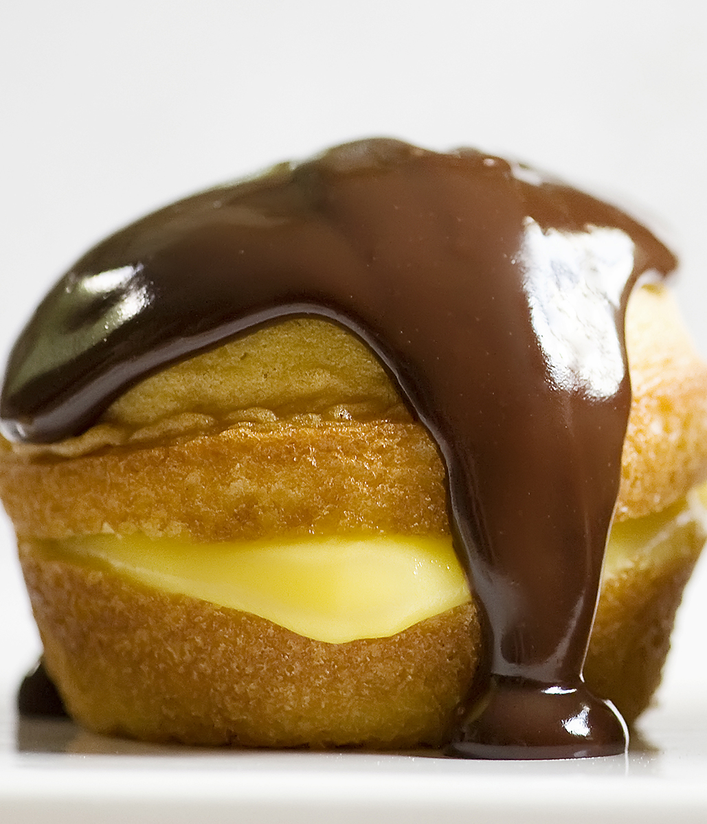 Boston Cream Pie Cupcake with chocolate drizzle.