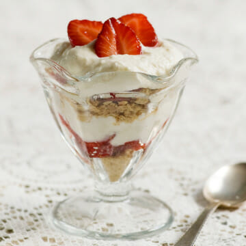 Strawberry cheesecake parfait in a dish with a spoon.
