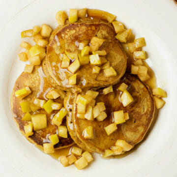 Gingerbread pancakes with apples on a plate.