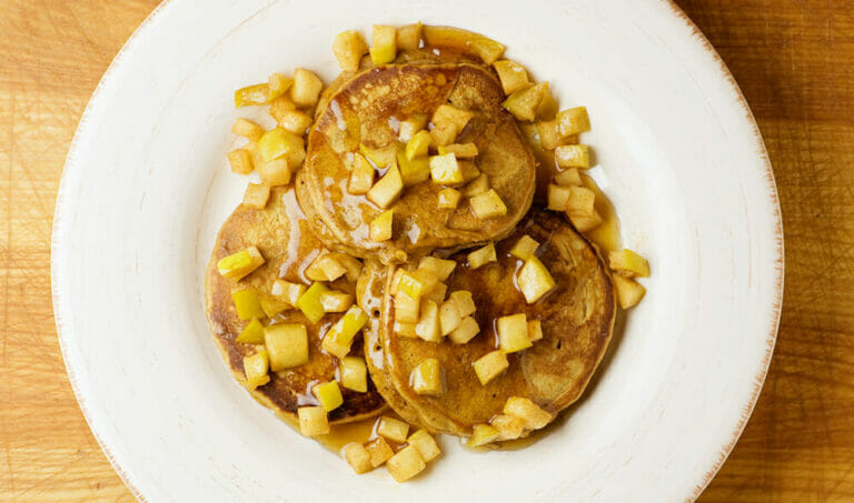 Gingerbread pancakes with apples on a plate.