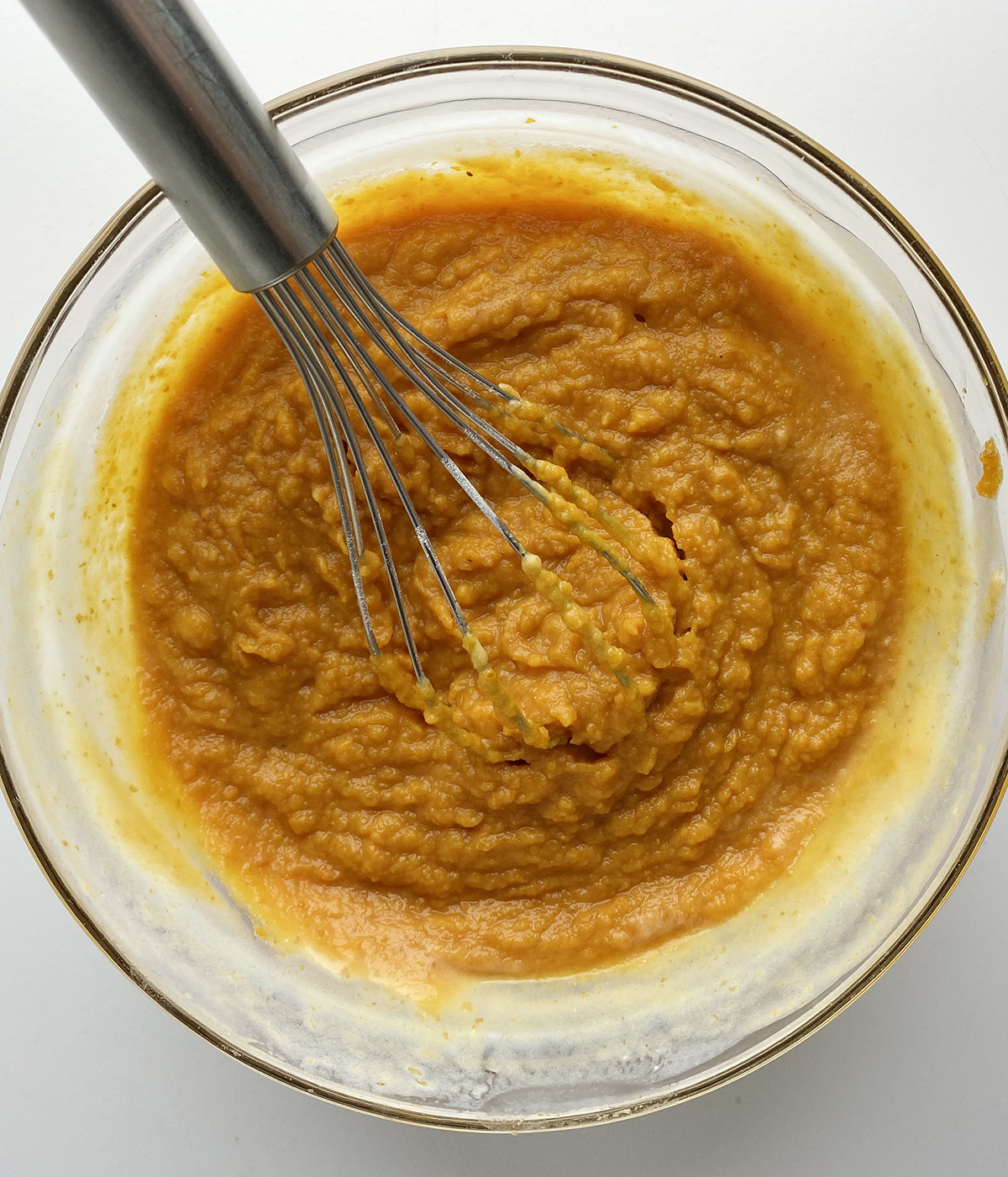 Buttermilk and pumpkin puree mixture in a mixing bowl.