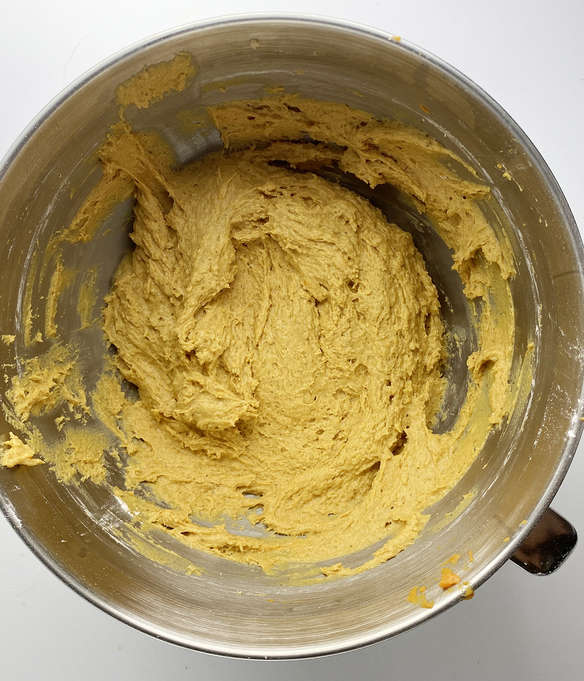 Finished pumpkin muffin batter in a mixing bowl.