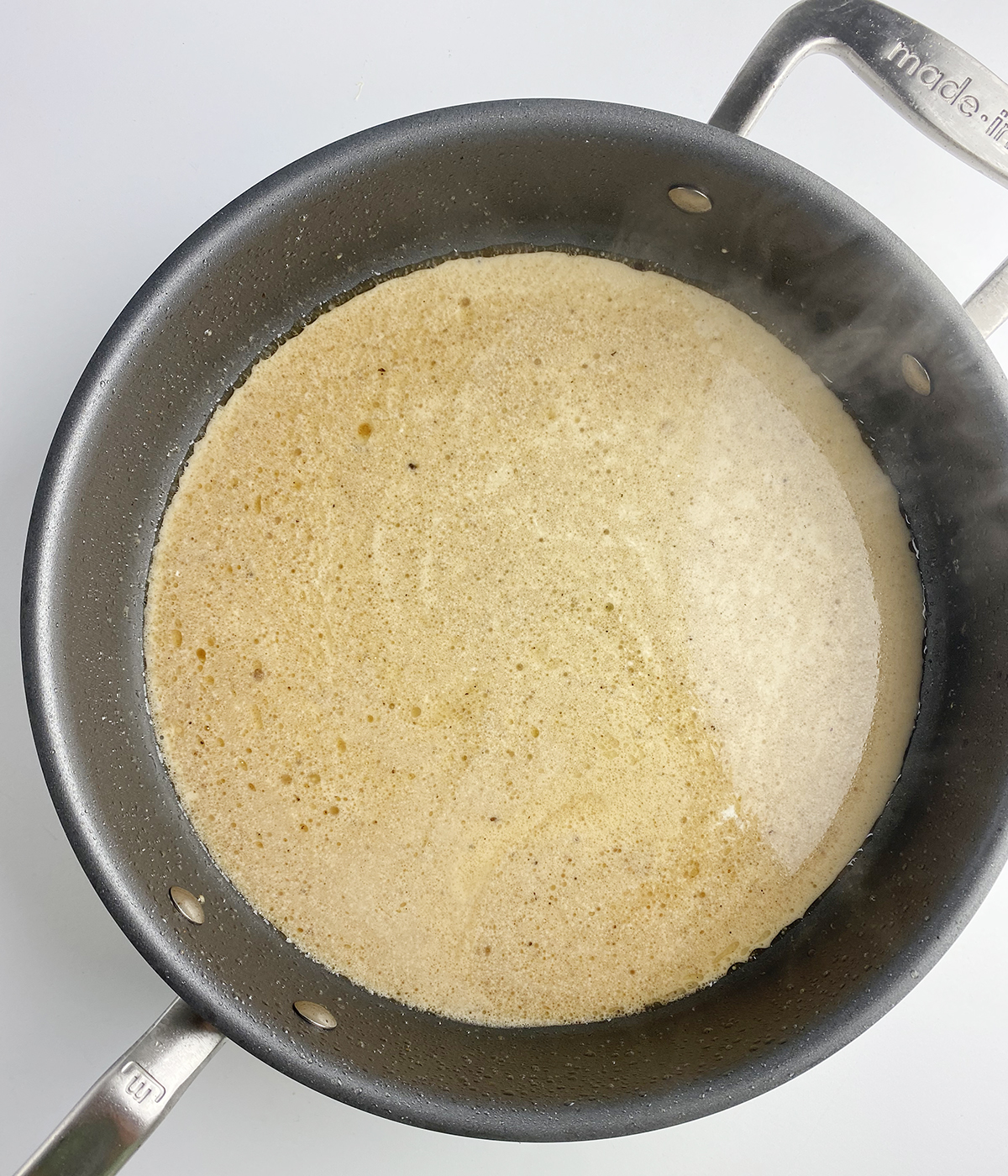 Creamy chicken marsala sauce in a skillet.