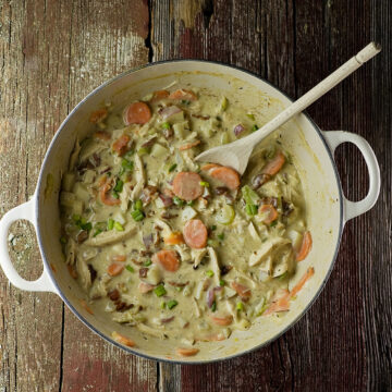 Creamy chicken stew on a wooden table.