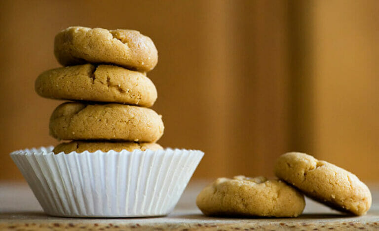 Peanut butter cookies in a stack.
