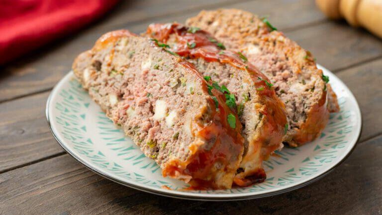 Ricotta meatloaf slices on a plate.