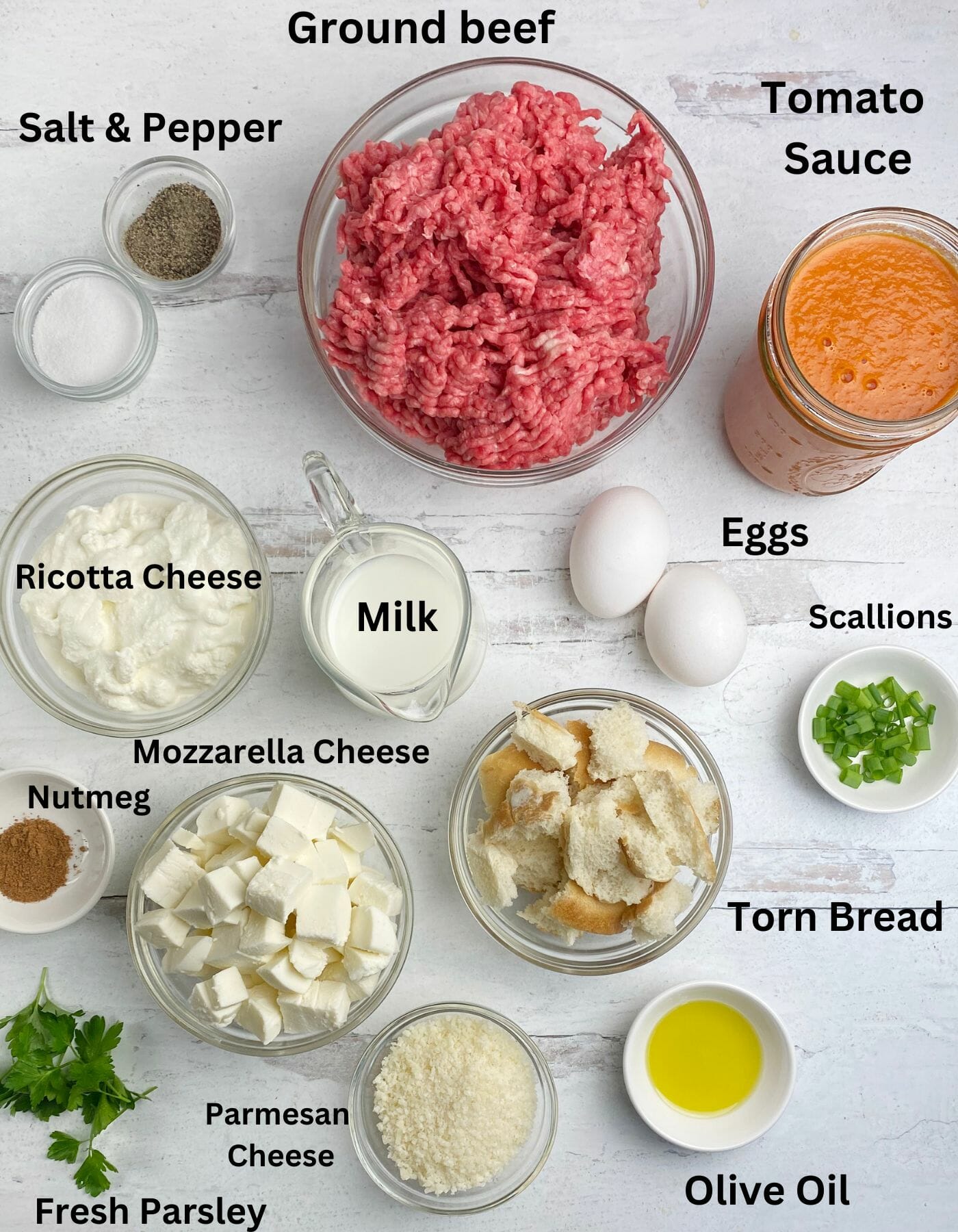Ricotta cheese meatloaf ingredients on a wooden counter.