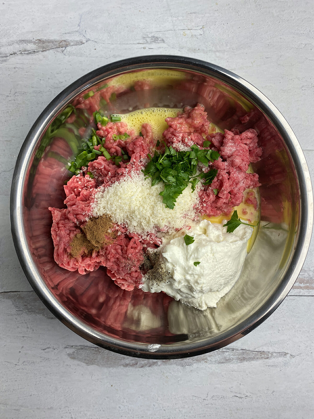 Ricotta meatloaf ingredients in a bowl.